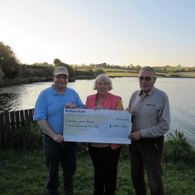BAC Joe McCandless, Joint President and Martin Dynes present the Club's charity donation to Katrina Leonard, Southern Area Hospice