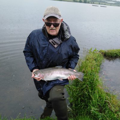 BAC - A 'studious' Wilson 'Skippy' Clinghan with a cracking Rainbow of 6lbs 10 ozs taken on the fly at Corbet Lough on Saturday 15 June 2019. Wilson sportingly returned this great fish.