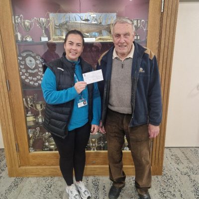 BAC - Club President Joe McCandless presents a cheque for £400 to Jamie McCann, Cancer Focus NI from monies raised from the sale of Joe's birdseed at the Corbet Lough during 2023